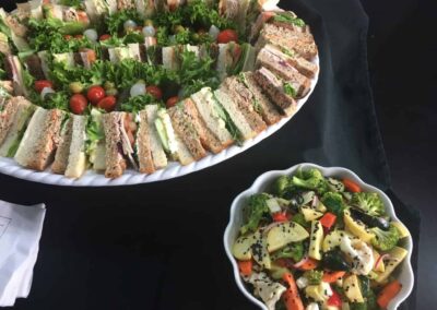 Finger sandwiches and salad display scaled 1